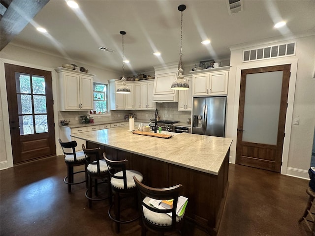 kitchen featuring light countertops, visible vents, finished concrete flooring, and stainless steel fridge with ice dispenser