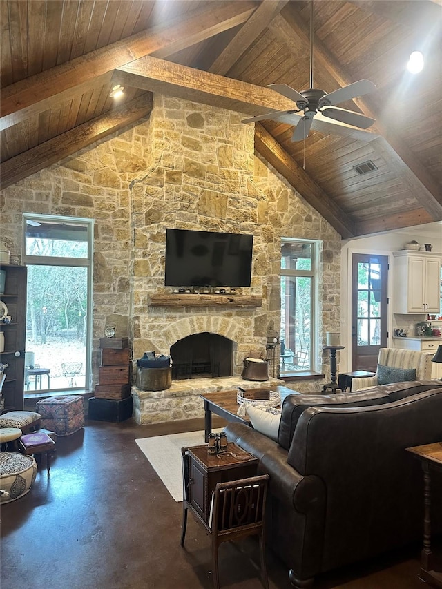 living area with wood ceiling, visible vents, beamed ceiling, and a stone fireplace