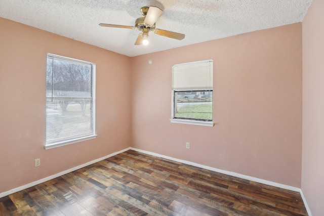 unfurnished room featuring a textured ceiling, ceiling fan, wood finished floors, and baseboards