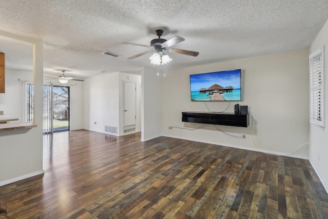 unfurnished living room featuring a ceiling fan, visible vents, a textured ceiling, and wood finished floors