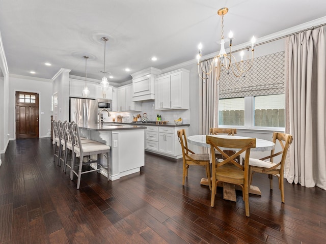 kitchen featuring dark countertops, appliances with stainless steel finishes, and dark wood-type flooring