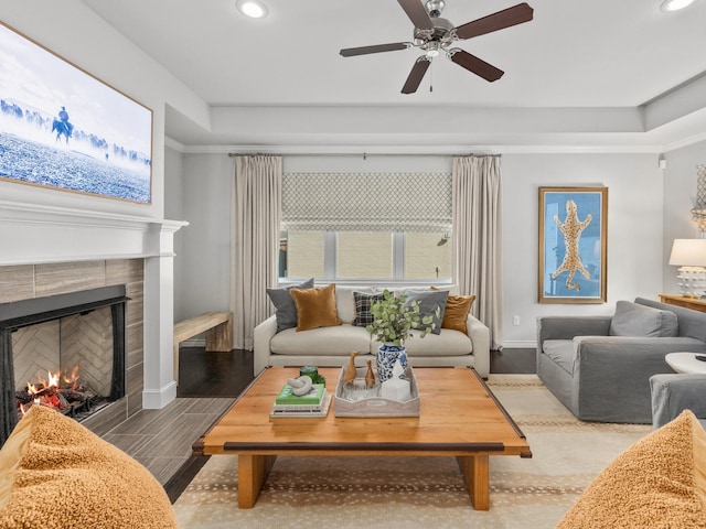 living area featuring wood finished floors, recessed lighting, a tile fireplace, and baseboards