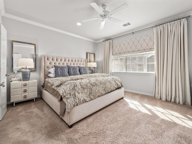 carpeted bedroom with visible vents, crown molding, baseboards, and ceiling fan