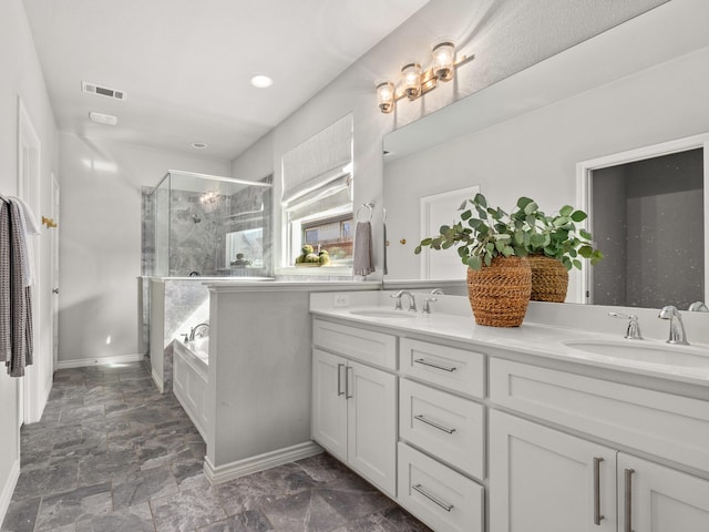 full bathroom with a stall shower, visible vents, a sink, and double vanity