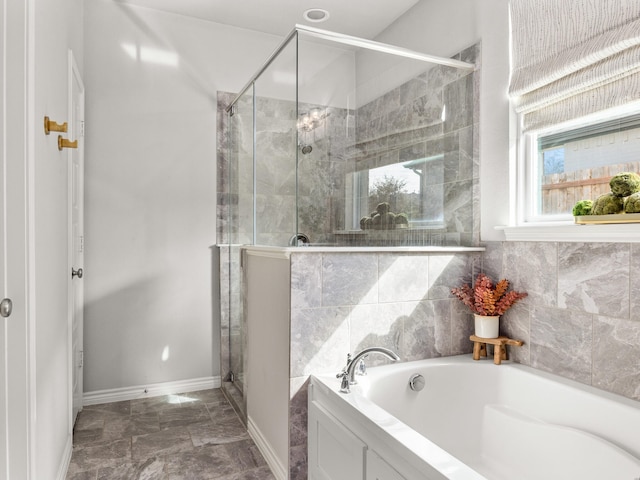 full bathroom featuring a stall shower, baseboards, and a bath