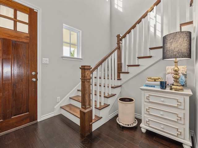 entryway featuring stairway, baseboards, and hardwood / wood-style floors