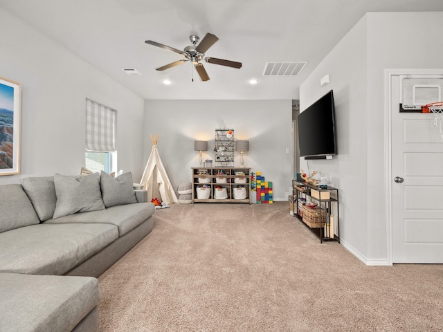 living room featuring carpet, visible vents, ceiling fan, and baseboards