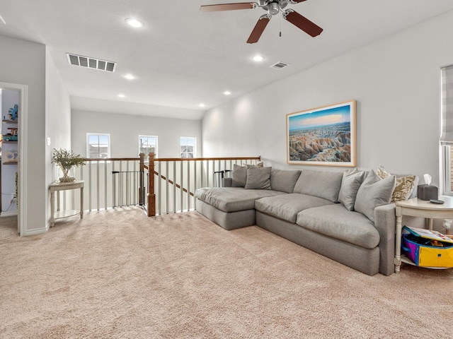 living room with carpet floors, recessed lighting, and visible vents