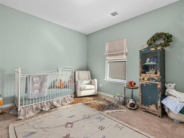 carpeted bedroom featuring visible vents and baseboards