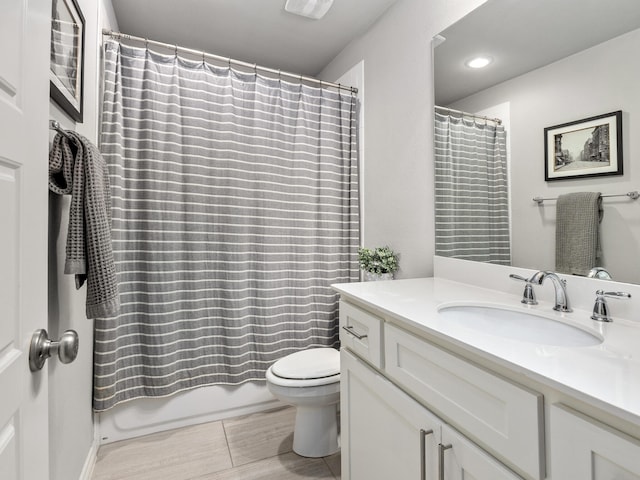 bathroom featuring shower / bath combo, vanity, and toilet