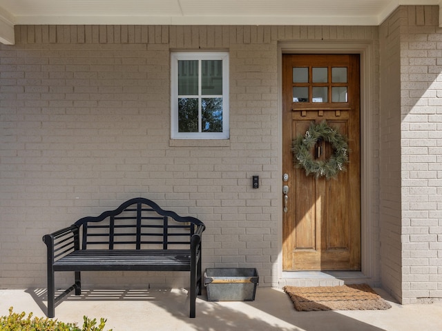 property entrance featuring brick siding