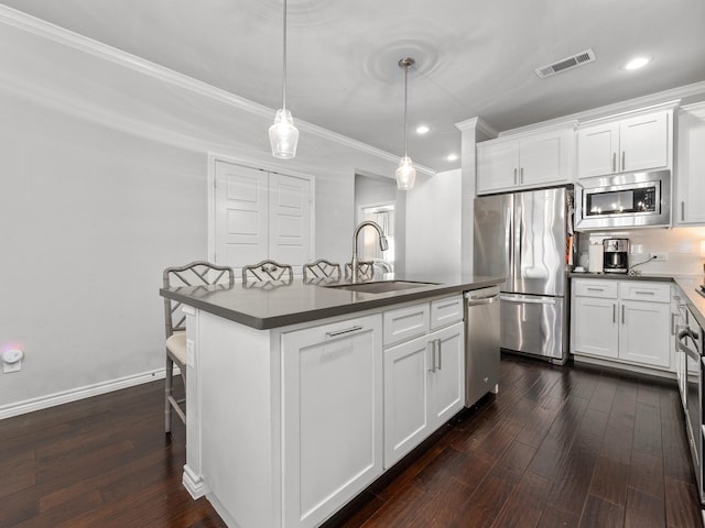 kitchen featuring stainless steel appliances, a sink, visible vents, white cabinetry, and dark countertops