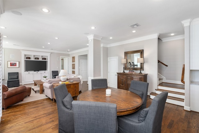 dining room with decorative columns, recessed lighting, visible vents, stairway, and wood finished floors