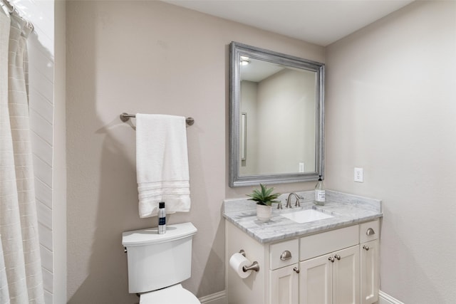 full bathroom featuring vanity, toilet, and baseboards