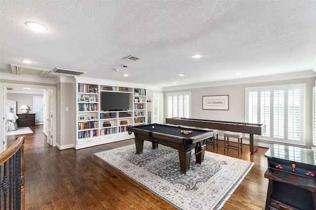 playroom with visible vents, a wealth of natural light, wood finished floors, and attic access