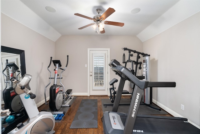 exercise area featuring lofted ceiling, baseboards, and wood finished floors