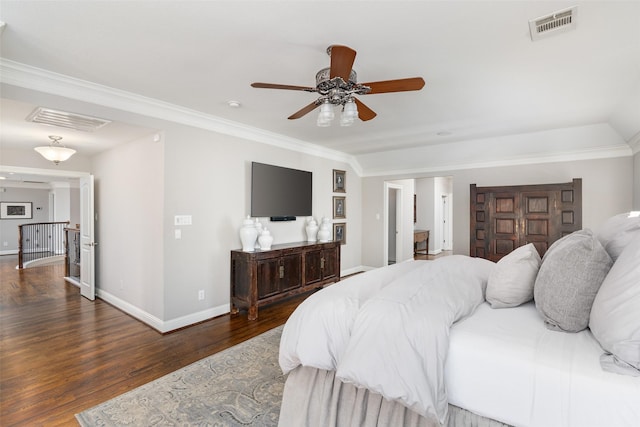 bedroom featuring ornamental molding, visible vents, and wood finished floors