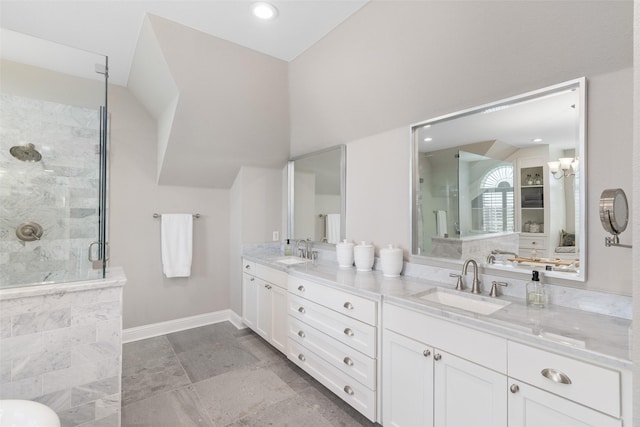 bathroom featuring vaulted ceiling, a stall shower, and a sink