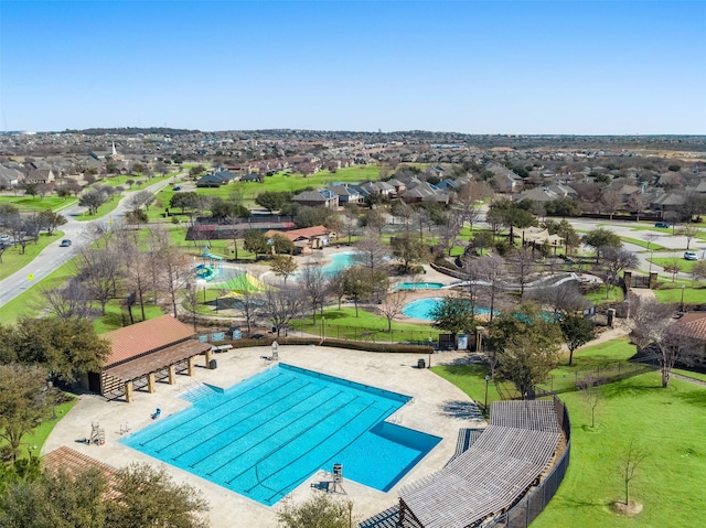 pool featuring a residential view, fence, and a patio