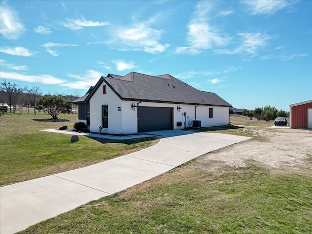 view of side of property with driveway, roof with shingles, a lawn, and stucco siding