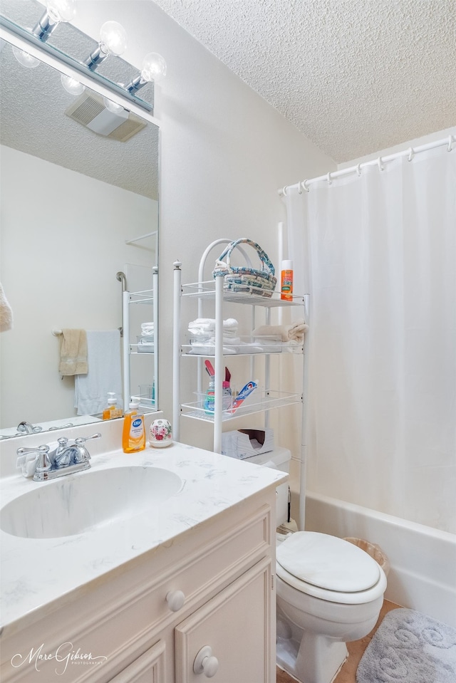 full bathroom featuring a textured ceiling, toilet, vanity, visible vents, and shower / bathtub combination with curtain