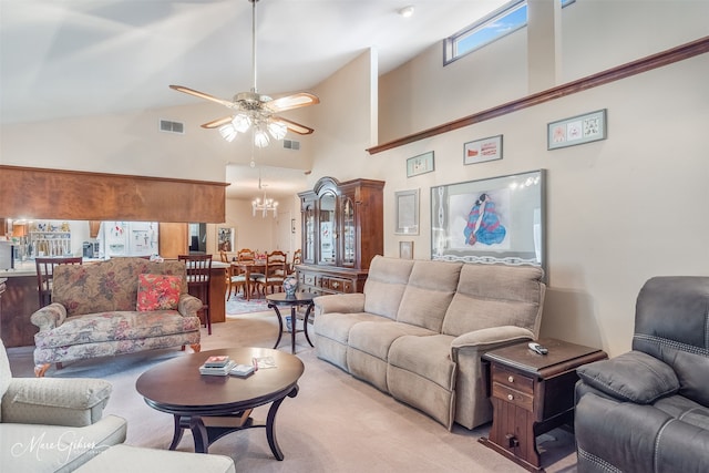 living area featuring ceiling fan with notable chandelier and visible vents