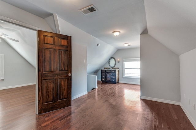 additional living space with baseboards, visible vents, a ceiling fan, lofted ceiling, and wood finished floors