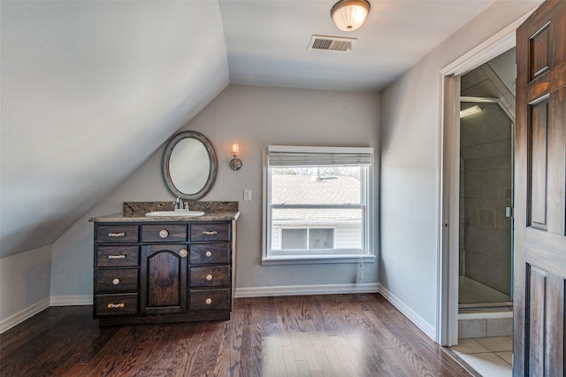 bathroom featuring visible vents, baseboards, and wood finished floors