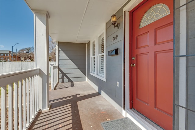 view of exterior entry featuring covered porch