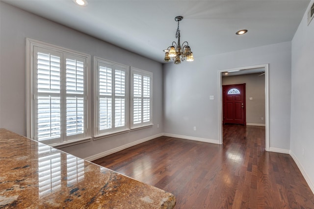 unfurnished dining area featuring dark wood-style flooring, recessed lighting, visible vents, and baseboards