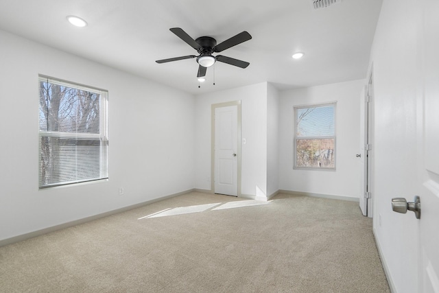 unfurnished bedroom with recessed lighting, light colored carpet, and baseboards