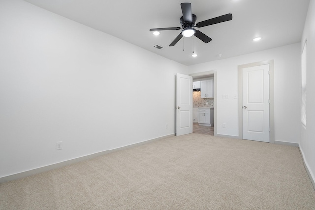 unfurnished bedroom with baseboards, visible vents, a ceiling fan, light colored carpet, and recessed lighting