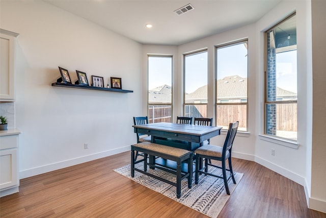 dining area with light wood-style floors, baseboards, visible vents, and recessed lighting