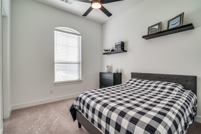 bedroom featuring a ceiling fan, carpet flooring, visible vents, and baseboards