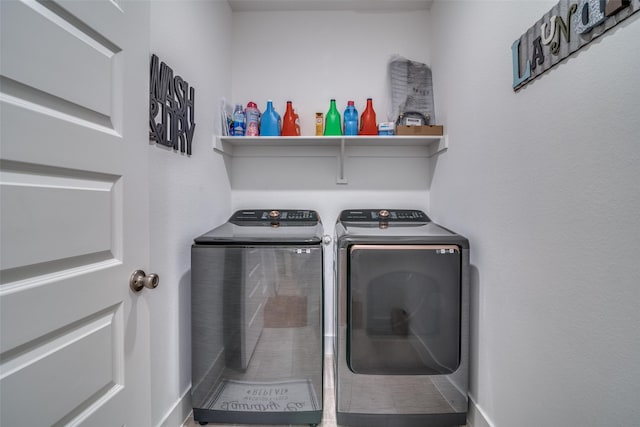 laundry room with laundry area and washing machine and clothes dryer