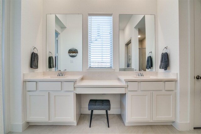 bathroom with a shower stall and vanity