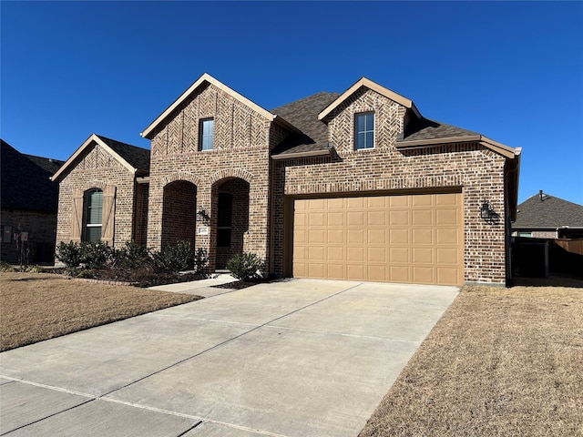 view of front of property featuring concrete driveway, brick siding, an attached garage, and a shingled roof