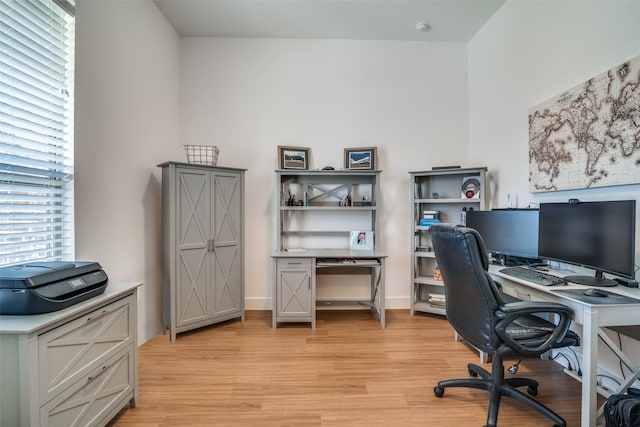 office with light wood-type flooring and baseboards