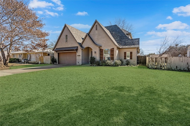 french provincial home with an attached garage, fence, brick siding, and driveway