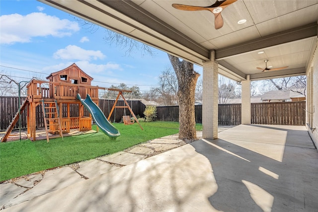 view of patio featuring a fenced backyard, ceiling fan, and a playground