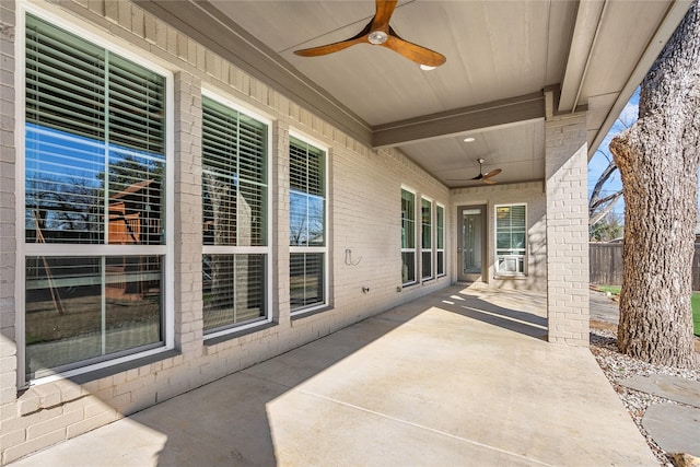 view of patio / terrace featuring fence and a ceiling fan