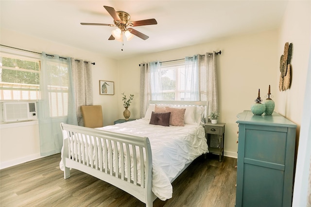 bedroom with ceiling fan, cooling unit, wood finished floors, and baseboards