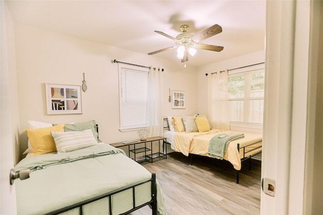 bedroom with a ceiling fan and wood finished floors