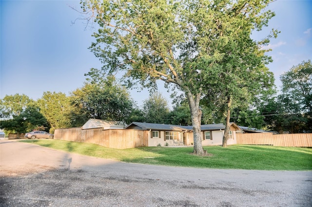 view of front of house with a front yard and fence