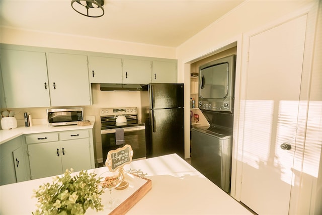 kitchen featuring stacked washer and clothes dryer, light countertops, appliances with stainless steel finishes, ornamental molding, and under cabinet range hood