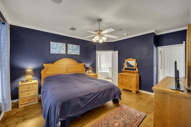 bedroom featuring ornamental molding, visible vents, baseboards, and hardwood / wood-style flooring