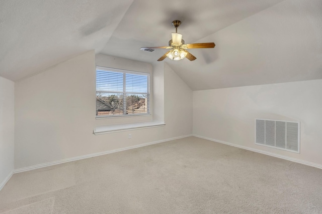 bonus room with lofted ceiling, baseboards, visible vents, and carpet flooring