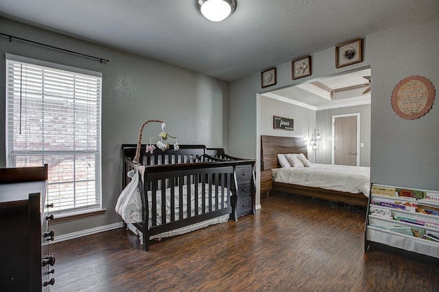 bedroom featuring crown molding, wood finished floors, and baseboards