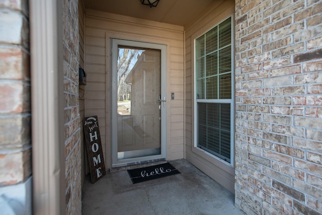 entrance to property with brick siding