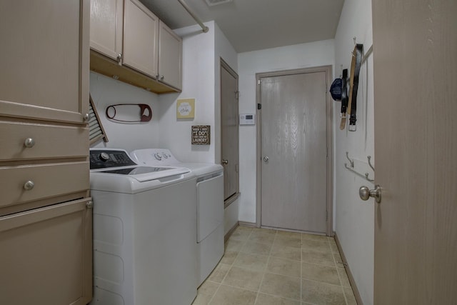 laundry room featuring cabinet space, independent washer and dryer, baseboards, and light tile patterned flooring